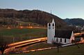 Night is falling on the Lutheran Church of Oberdorf and the small trains passing by.