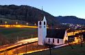 Night is falling on the Lutheran Church of Oberdorf and the small trains passing by.