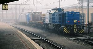3 CFL locomotives are standing in the fog: a class 1100 diesel loco, an older diesel in the middle...