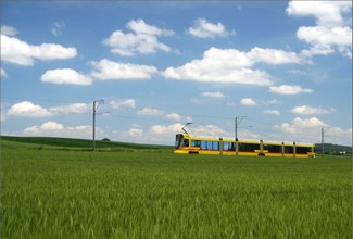 Stadler's TANGO tram approaches from Ettingen