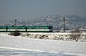 Am Rand von Pomáz fährt der MXA-Zug im Schnee Richtung Szentendre