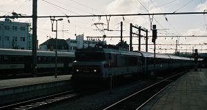 A class BB 15000 (no. 15024) electric loco of SNCF is arriving with her express train.