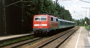 A regional train towards Kufstein (Austria) is arriving , hauled by the electric locomotive 111 067.