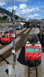 Two class HGe 4/4 II electric locos of MGB are waiting at the western exit of the station.